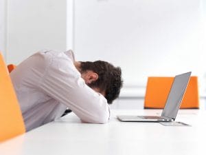 frustrated young business man at office, reduce office stress